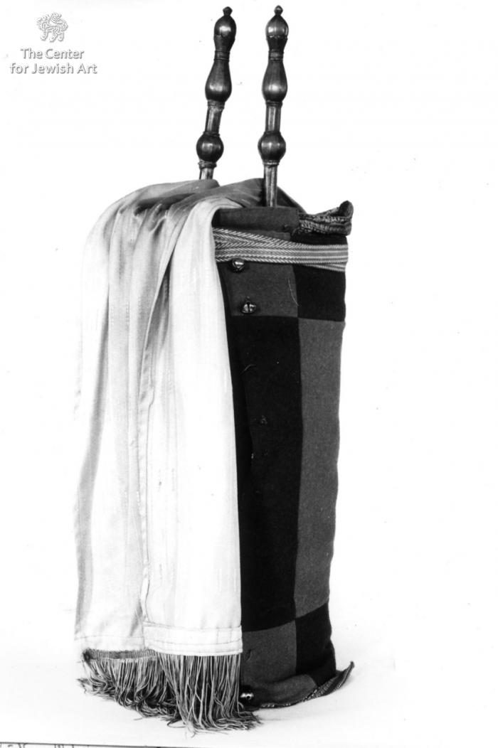A Yemenite Torah case with finials. The object shows the vertical case tradition that kept the scroll upright in Yemeni synagogues.
